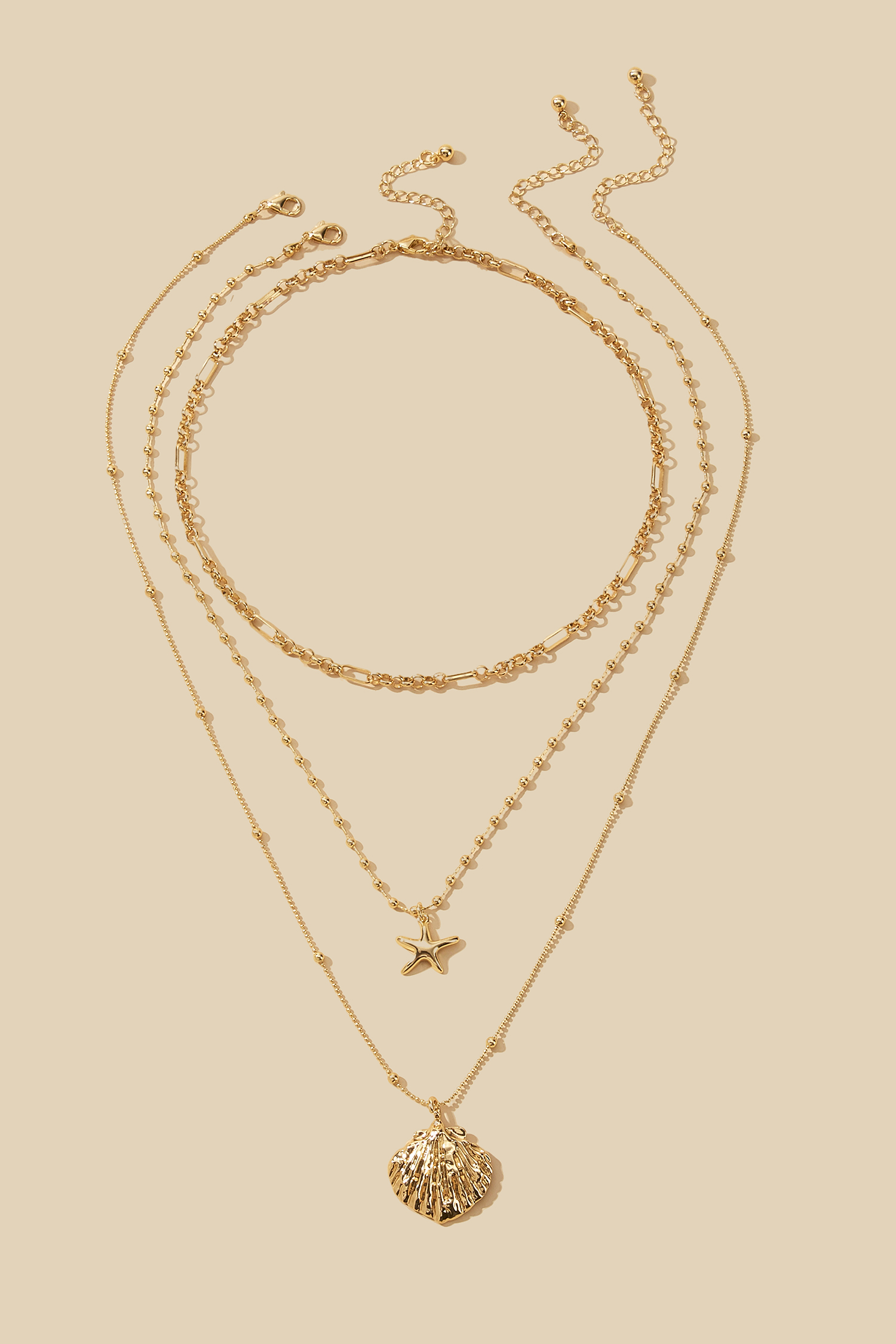 Goldfarbene Halskette mit Meeresmotiven